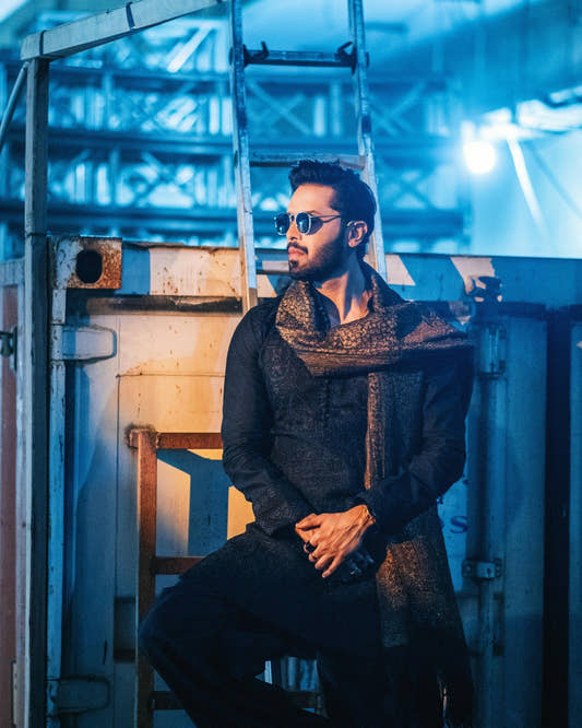 Fahad Mustafa wearing Snug black farshi outfit for men with embroidered shawl premium ethnic wear